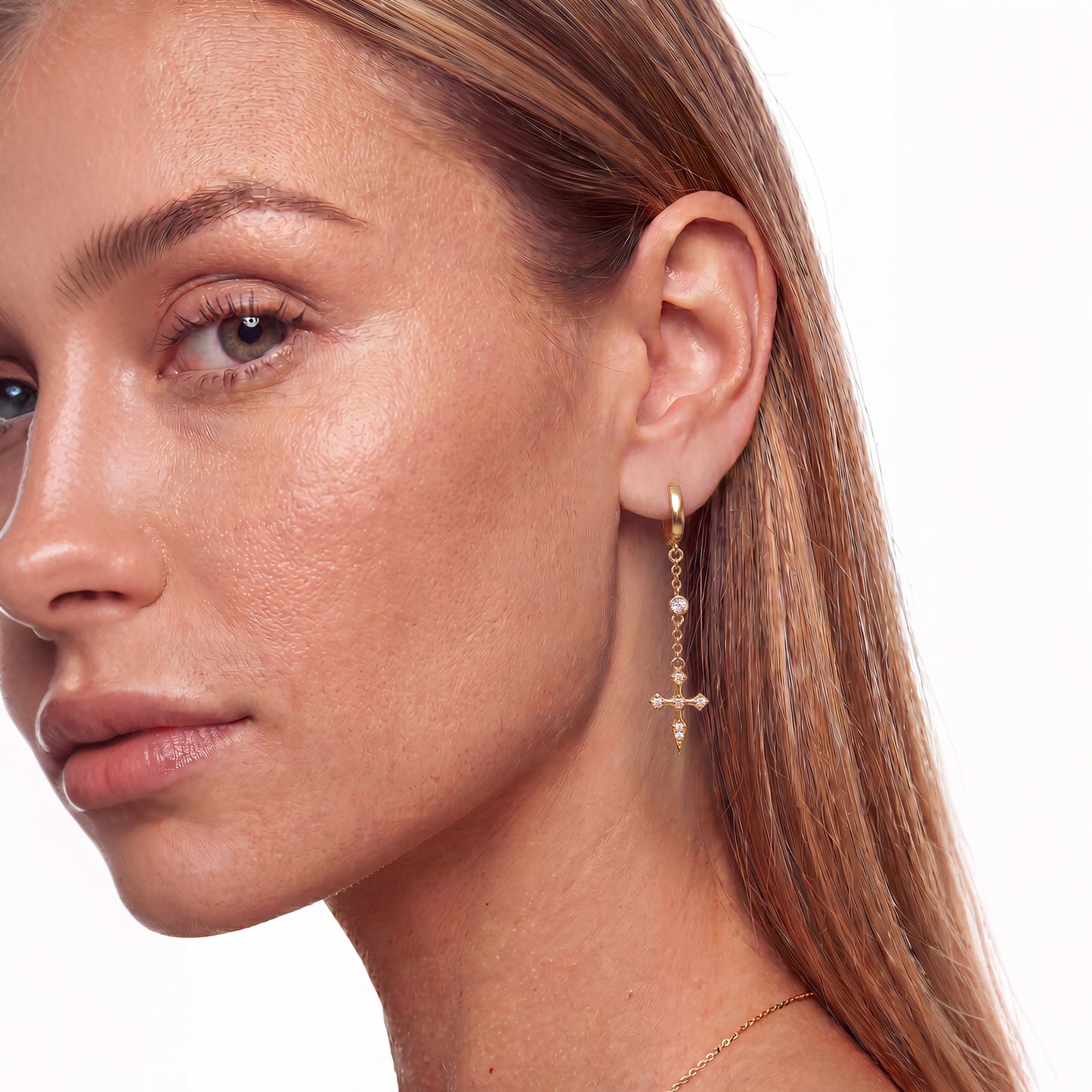 Asymmetrical earrings with cross & dagger charms